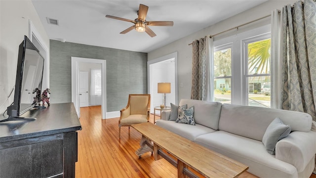 423 Ave H SE, Winter Haven, FL 33880 - living area featuring wallpapered walls, ceiling fan, and light wood finished floors