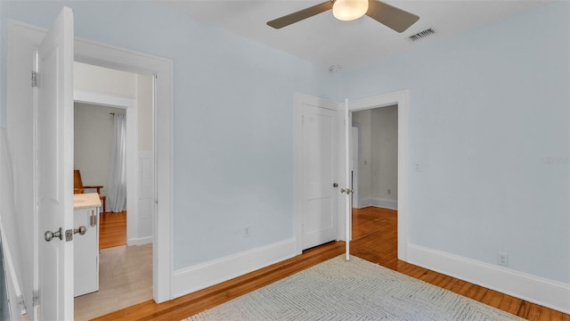 423 Ave H SE, Winter Haven, FL 33880 - bedroom with wood finished floors and ceiling fan