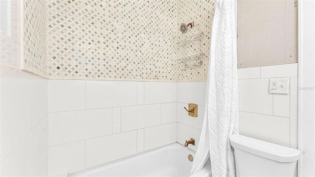 423 Ave H SE, Winter Haven, FL 33880 - bathroom with tile walls, shower / bathtub combination with curtain, and a wainscoted wall