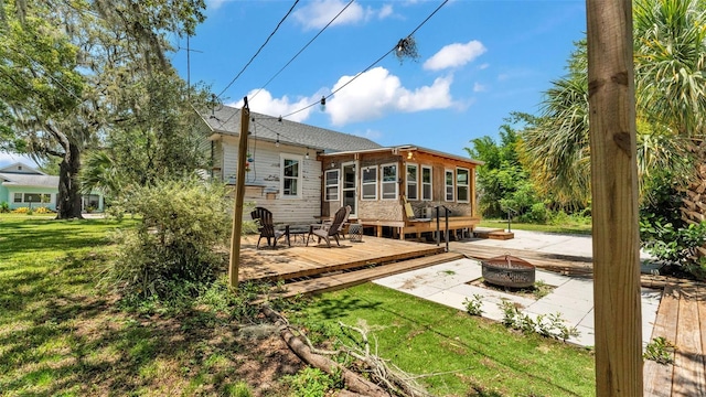 423 Ave H SE, Winter Haven, FL 33880 - rear view of property featuring a fire pit, a deck, and a yard