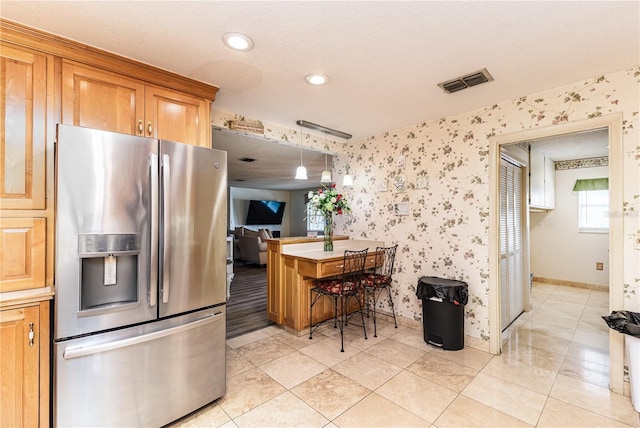 521 Lone Palm Dr, Lakeland, FL 33815 - kitchen featuring stainless steel fridge with ice dispenser, wallpapered walls, recessed lighting, brown cabinets, and pendant lighting