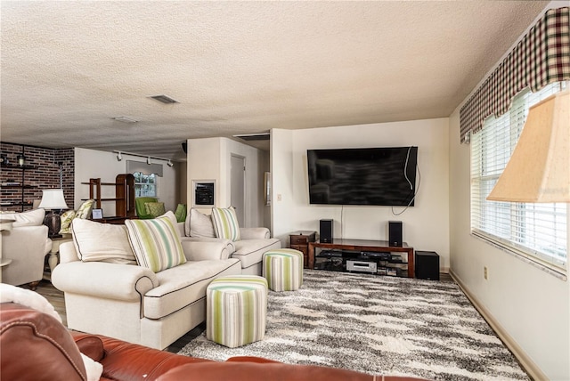 521 Lone Palm Dr, Lakeland, FL 33815 - carpeted living area with a textured ceiling and baseboards