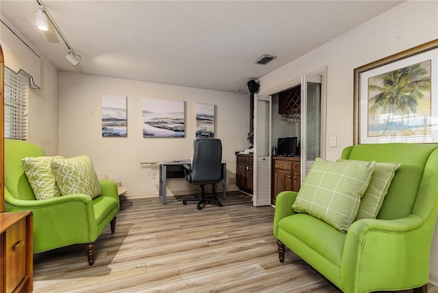521 Lone Palm Dr, Lakeland, FL 33815 - office area with light wood-style floors, rail lighting, and a textured ceiling