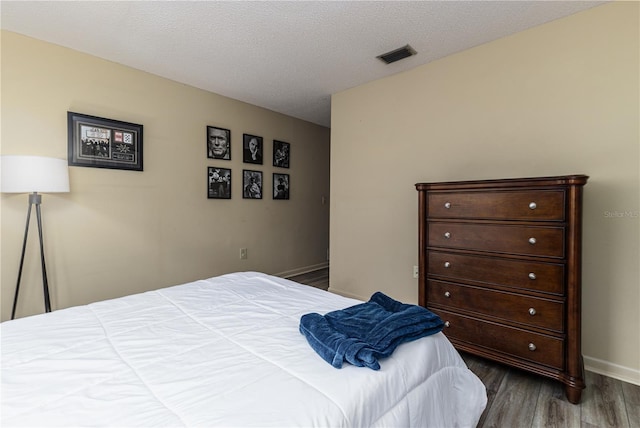 521 Lone Palm Dr, Lakeland, FL 33815 - bedroom with dark wood-type flooring and a textured ceiling