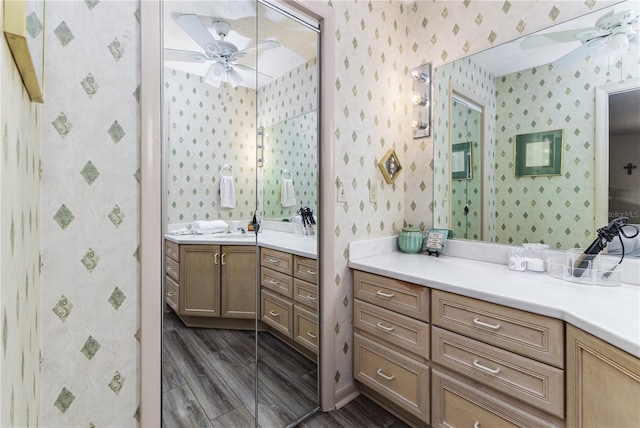 521 Lone Palm Dr, Lakeland, FL 33815 - bathroom with wallpapered walls, ceiling fan, and vanity