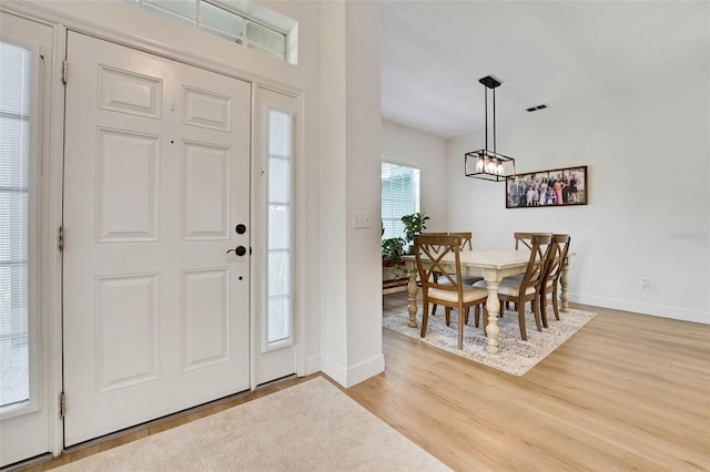 122 Amber Blvd, Auburndale, FL 33823 - entryway with light wood-style flooring and a chandelier