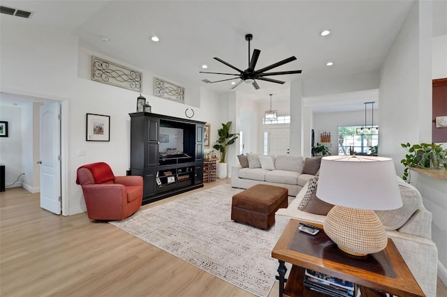 122 Amber Blvd, Auburndale, FL 33823 - living area featuring light wood finished floors, recessed lighting, a ceiling fan, and a chandelier