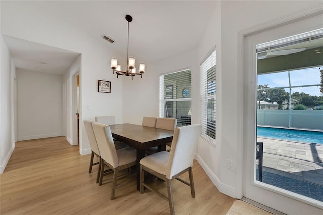122 Amber Blvd, Auburndale, FL 33823 - dining space with light wood finished floors and a chandelier