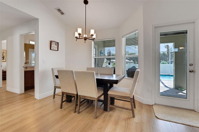 122 Amber Blvd, Auburndale, FL 33823 - dining space featuring light wood-style flooring and a chandelier
