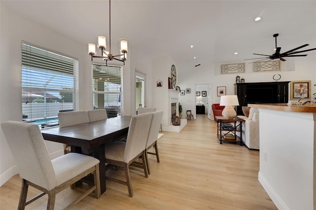 122 Amber Blvd, Auburndale, FL 33823 - dining room featuring a chandelier, a ceiling fan, light wood-style flooring, recessed lighting, and high vaulted ceiling