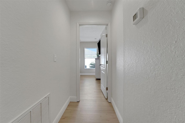 122 Amber Blvd, Auburndale, FL 33823 - hallway with a textured wall and light wood-style floors