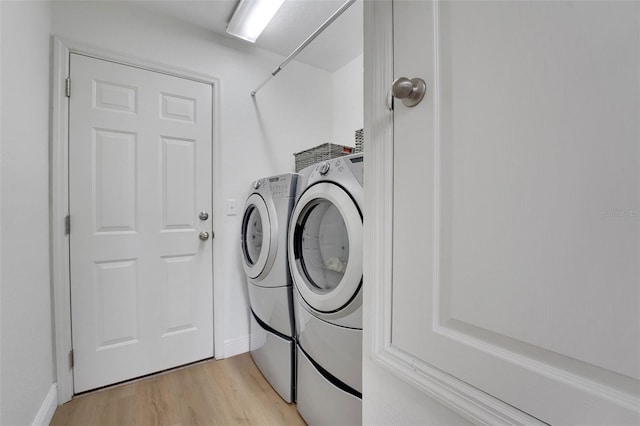 122 Amber Blvd, Auburndale, FL 33823 - laundry room with separate washer and dryer and light wood-style floors
