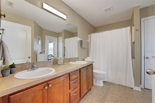 122 Amber Blvd, Auburndale, FL 33823 - bathroom with double vanity, tile patterned floors, and a shower with shower curtain