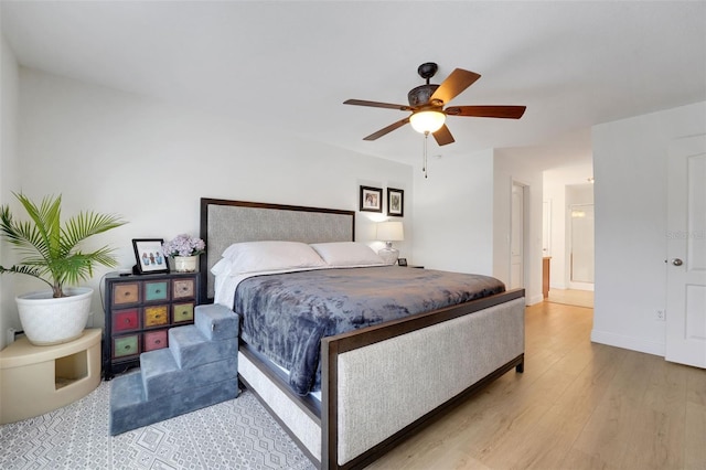 122 Amber Blvd, Auburndale, FL 33823 - bedroom with wood finished floors, ceiling fan, and connected bathroom