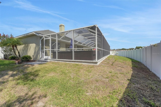 122 Amber Blvd, Auburndale, FL 33823 - rear view of house with a fenced backyard, a chimney, and a lanai