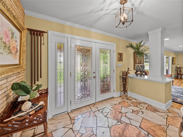 2213 Woodbine Ave, Lakeland, FL 33803 - entrance foyer with decorative columns, french doors, crown molding, stone finish floors, and a chandelier