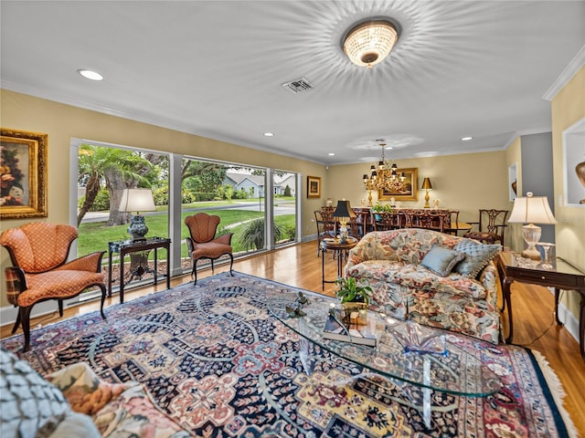 2213 Woodbine Ave, Lakeland, FL 33803 - living room featuring wood finished floors, ornamental molding, recessed lighting, and a chandelier