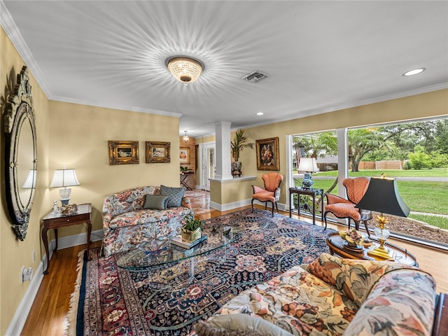 2213 Woodbine Ave, Lakeland, FL 33803 - living room with decorative columns, healthy amount of natural light, ornamental molding, wood finished floors, and recessed lighting