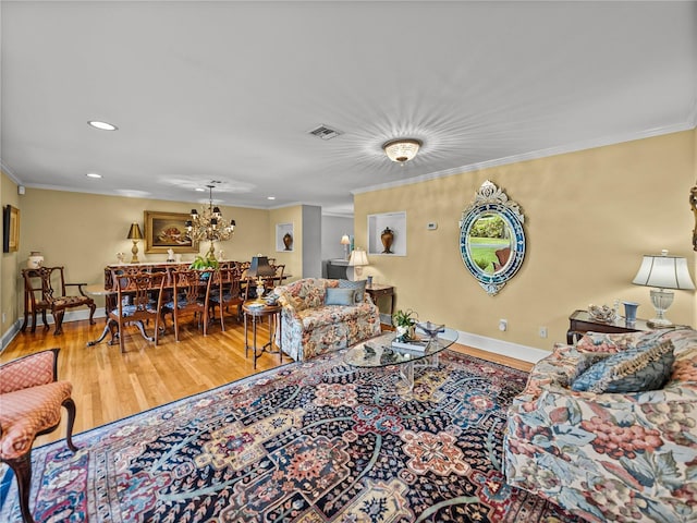 2213 Woodbine Ave, Lakeland, FL 33803 - living room with wood finished floors, ornamental molding, recessed lighting, and a chandelier