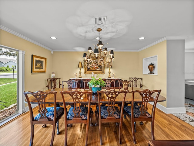 2213 Woodbine Ave, Lakeland, FL 33803 - dining room with recessed lighting, ornamental molding, light wood finished floors, and a chandelier