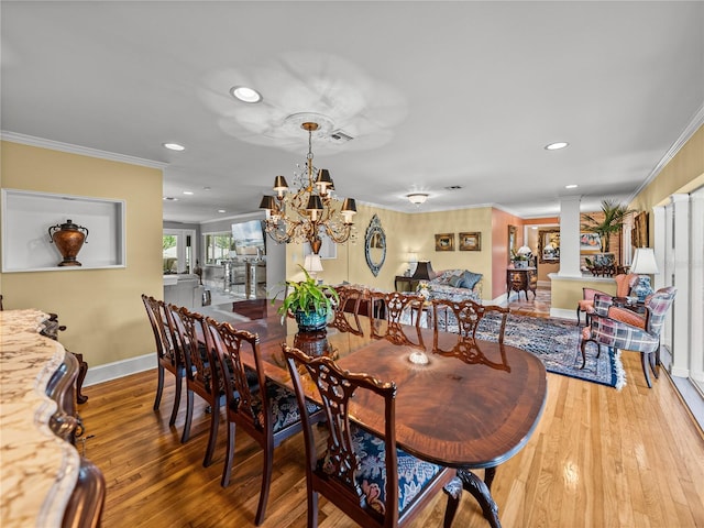 2213 Woodbine Ave, Lakeland, FL 33803 - dining space featuring crown molding, recessed lighting, light wood-style flooring, a chandelier, and ornate columns