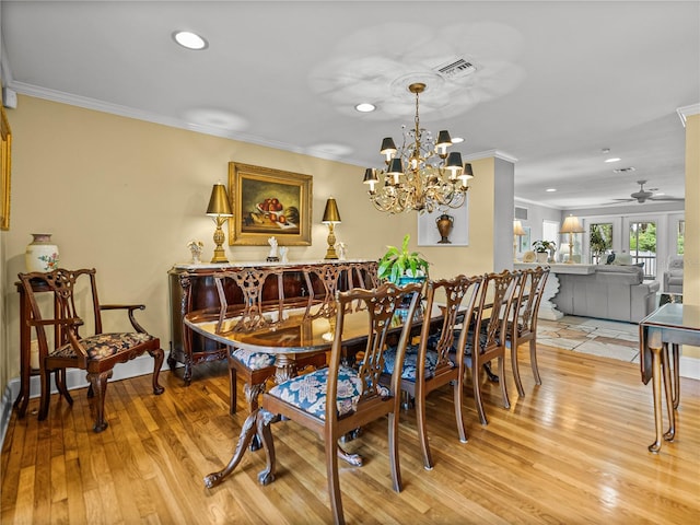 2213 Woodbine Ave, Lakeland, FL 33803 - dining space with ornamental molding, recessed lighting, light wood-type flooring, ceiling fan, and a chandelier