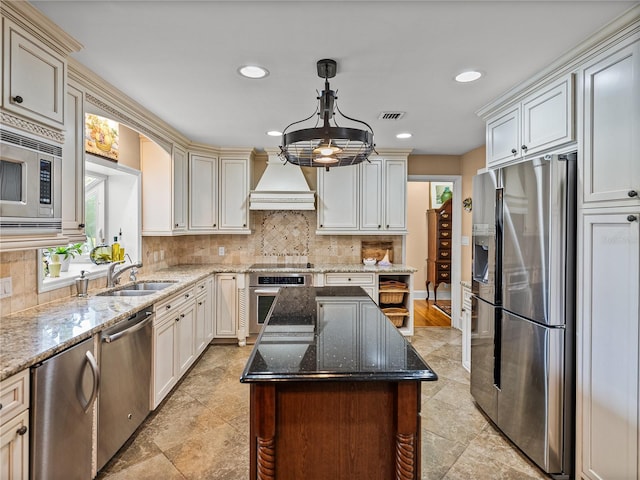 2213 Woodbine Ave, Lakeland, FL 33803 - kitchen with stainless steel appliances, custom exhaust hood, tasteful backsplash, recessed lighting, and dark stone counters