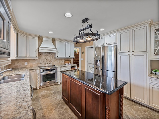 2213 Woodbine Ave, Lakeland, FL 33803 - kitchen featuring appliances with stainless steel finishes, custom range hood, recessed lighting, backsplash, and light stone counters
