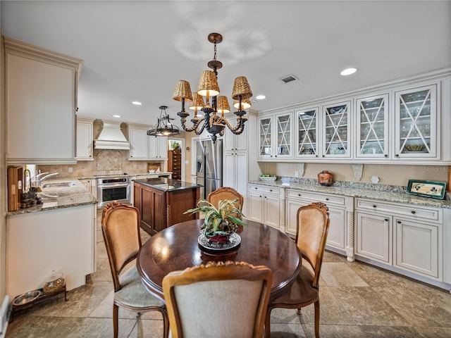 2213 Woodbine Ave, Lakeland, FL 33803 - dining space featuring a chandelier and recessed lighting