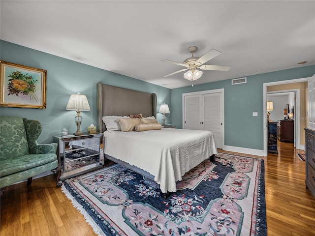 2213 Woodbine Ave, Lakeland, FL 33803 - bedroom featuring wood finished floors, a closet, and a ceiling fan