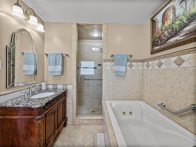 2213 Woodbine Ave, Lakeland, FL 33803 - bathroom featuring a jetted tub, a shower stall, vanity, tile patterned flooring, and tile walls