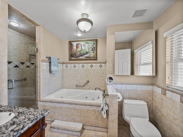 2213 Woodbine Ave, Lakeland, FL 33803 - full bath featuring a whirlpool tub, vanity, tile walls, a stall shower, and a wainscoted wall