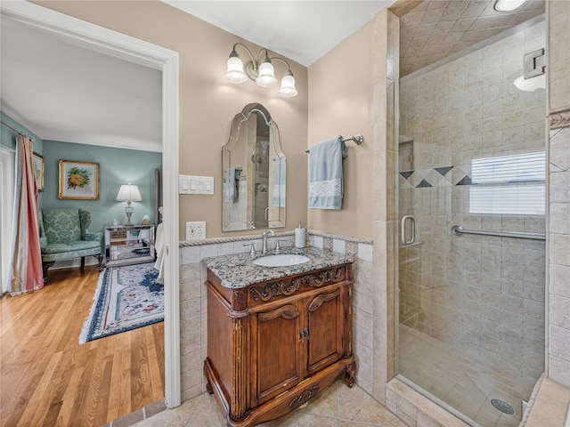 2213 Woodbine Ave, Lakeland, FL 33803 - bathroom with vanity, a shower stall, wood finished floors, and tile walls