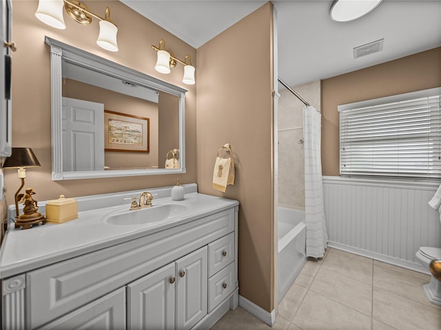 2213 Woodbine Ave, Lakeland, FL 33803 - full bath with vanity, shower / bathtub combination with curtain, tile patterned floors, and a wainscoted wall