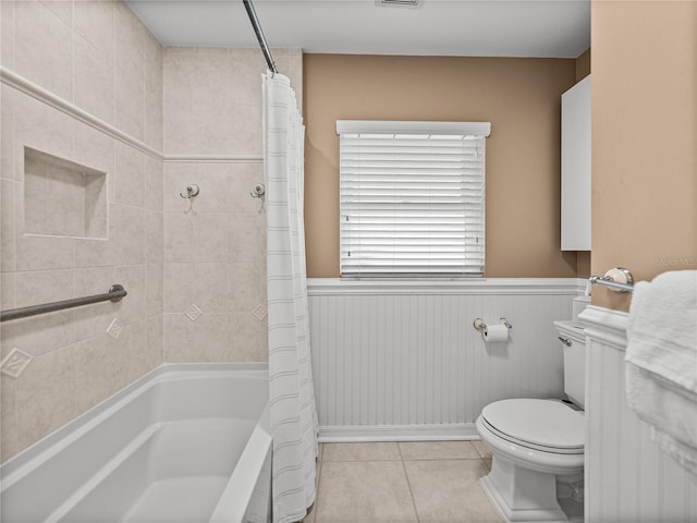 2213 Woodbine Ave, Lakeland, FL 33803 - bathroom with shower / tub combo, tile patterned flooring, and wainscoting