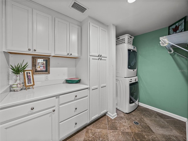 2213 Woodbine Ave, Lakeland, FL 33803 - laundry room featuring stacked washer / drying machine and cabinet space