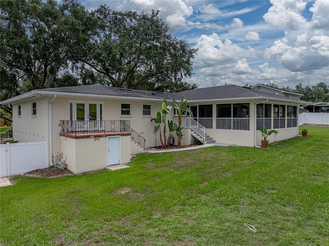 2213 Woodbine Ave, Lakeland, FL 33803 - rear view of house featuring a sunroom and stairway
