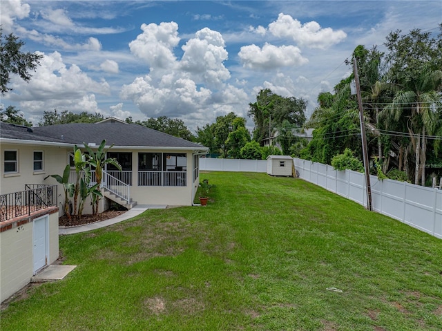 2213 Woodbine Ave, Lakeland, FL 33803 - fenced backyard with a sunroom and a storage unit