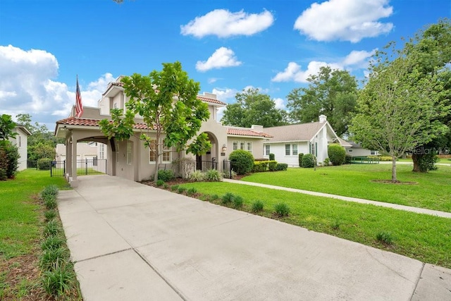 207 W Maxwell St, Lakeland, FL 33803 - mediterranean / spanish home featuring driveway, a carport, stucco siding, and a tiled roof