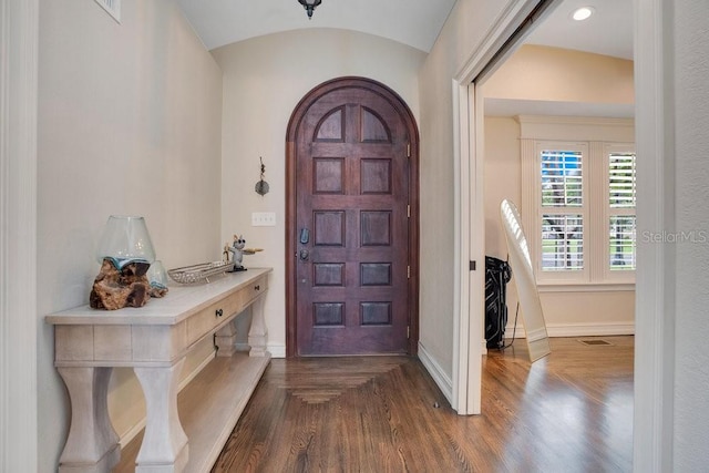 207 W Maxwell St, Lakeland, FL 33803 - foyer featuring arched walkways and dark wood-style flooring