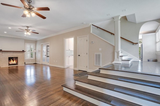 207 W Maxwell St, Lakeland, FL 33803 - unfurnished living room featuring stairs, a ceiling fan, a brick fireplace, ornamental molding, and parquet flooring