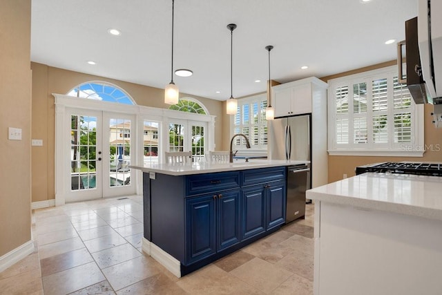 207 W Maxwell St, Lakeland, FL 33803 - kitchen with blue cabinets, dishwasher, french doors, decorative light fixtures, and recessed lighting