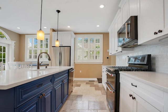207 W Maxwell St, Lakeland, FL 33803 - kitchen featuring appliances with stainless steel finishes, blue cabinets, backsplash, white cabinets, and recessed lighting