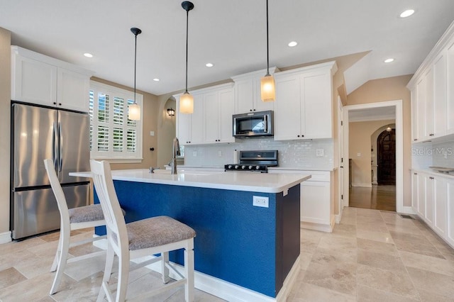 207 W Maxwell St, Lakeland, FL 33803 - kitchen with appliances with stainless steel finishes, backsplash, recessed lighting, white cabinets, and light countertops