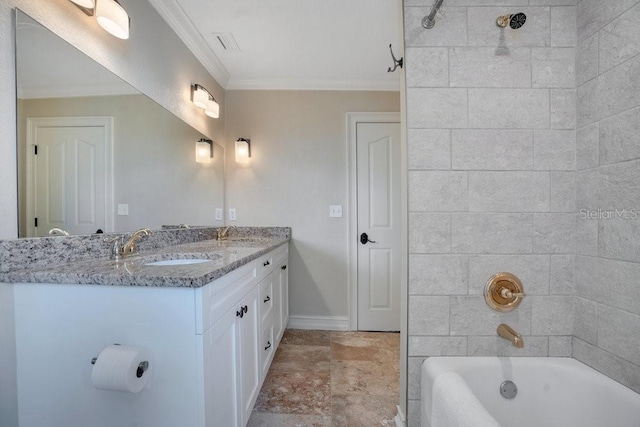 207 W Maxwell St, Lakeland, FL 33803 - bathroom featuring double vanity, crown molding, washtub / shower combination, and stone finish flooring