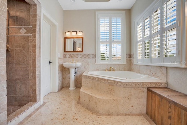207 W Maxwell St, Lakeland, FL 33803 - bathroom with a garden tub, tile walls, and a tile shower