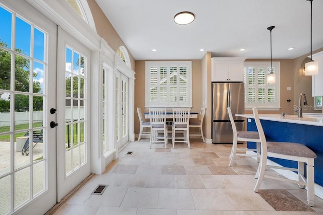 207 W Maxwell St, Lakeland, FL 33803 - kitchen featuring freestanding refrigerator, plenty of natural light, decorative light fixtures, light countertops, and recessed lighting
