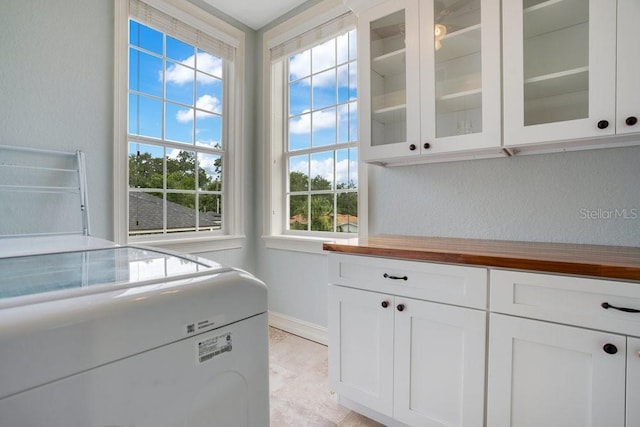 207 W Maxwell St, Lakeland, FL 33803 - laundry room with cabinet space, a textured wall, and washer and dryer