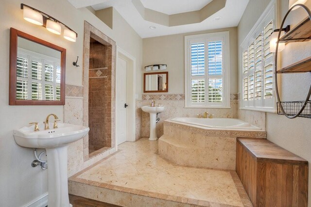 207 W Maxwell St, Lakeland, FL 33803 - full bathroom featuring tile walls, a bath, a tile shower, and tile patterned flooring