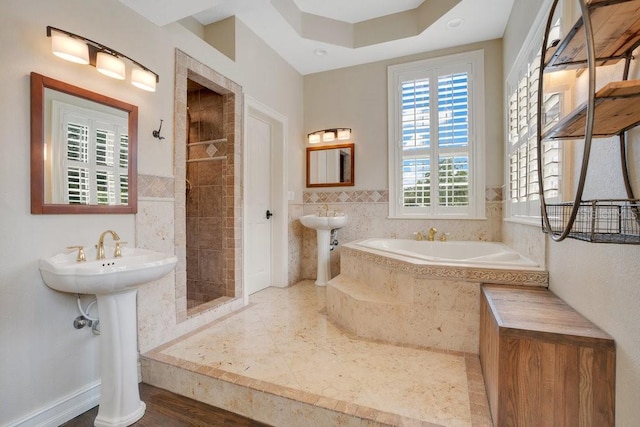 207 W Maxwell St, Lakeland, FL 33803 - bathroom featuring tiled shower, a bath, and tile walls